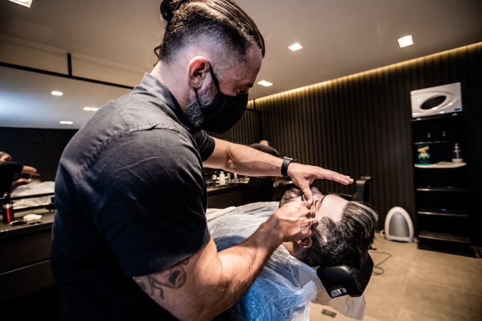 A barber shaving with a straight razor