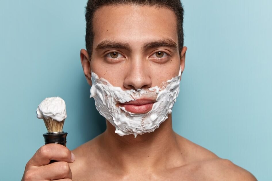 A man applying shaving cream